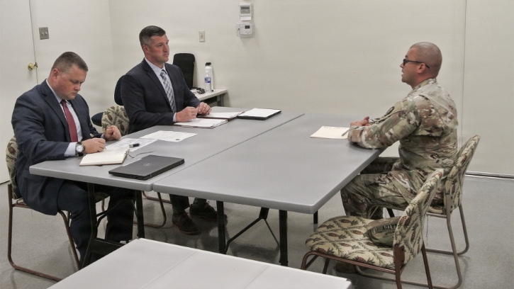 photo of instructors and military students in a clasroom